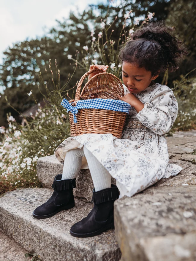 Little girl having a picnic wearing Pip and Henry Western Boots