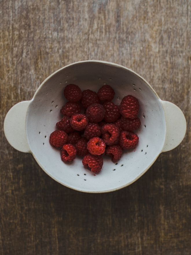 raspberries in handmade stoneware bowl