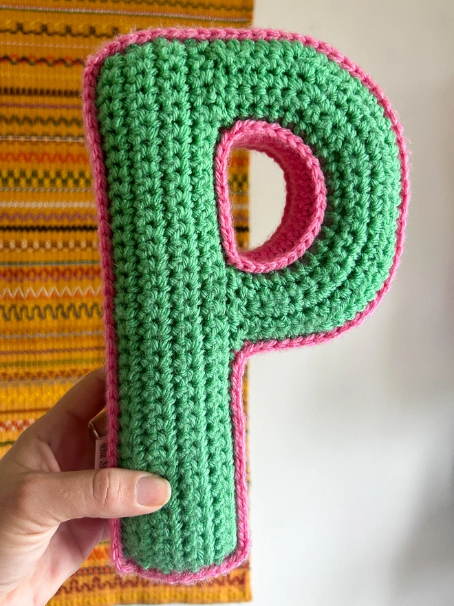 Crochet cushion in the shape of the letter P