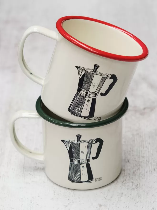 Picture of 2 Cream Enamel Mugs with a Moka Pot design etched onto it, taken from an original Lino Print. 1 has a green rim, and the other has a red rim.