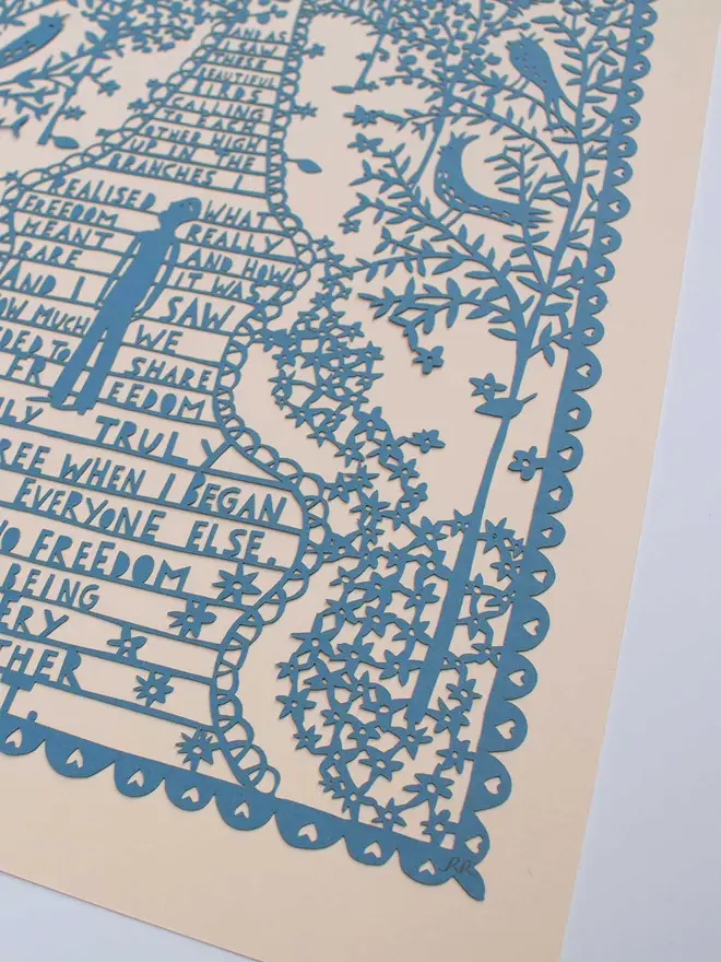 Close up image of the light blue lasercut in the beige folder