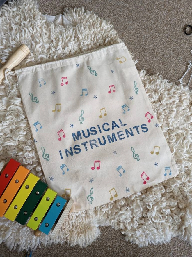 personalised musical bag. a drawstring bag with printed music symbols and a personalised name.