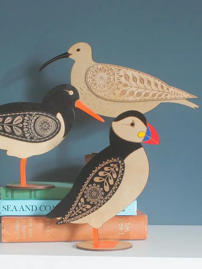 Standing Wooden Curlew, wooden bird decoration standing in a group with other birds on a platform