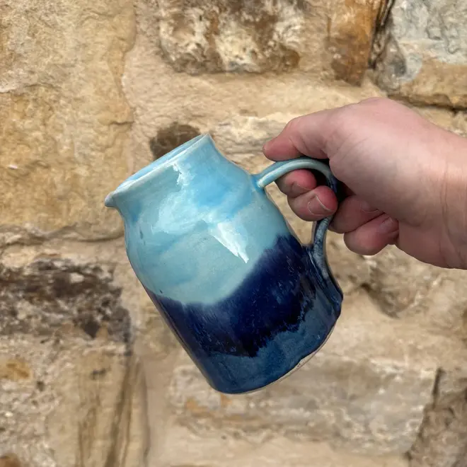 Landscape Medium Jug, a colourful jug sitting held against a brick backdrop. 