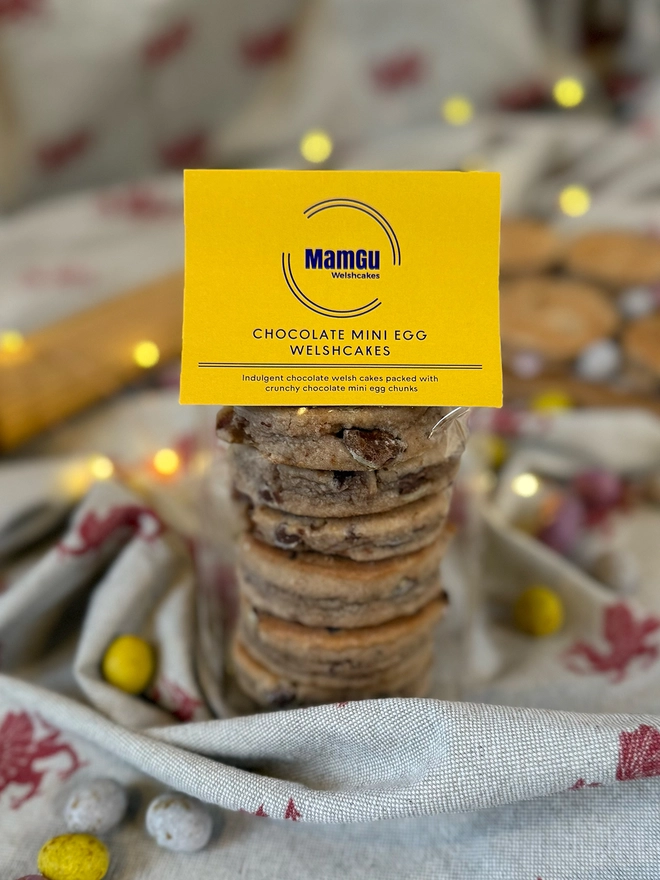 6 Mini Egg Welsh Cakes with a yellow MamGu Label and rustic kitchen background