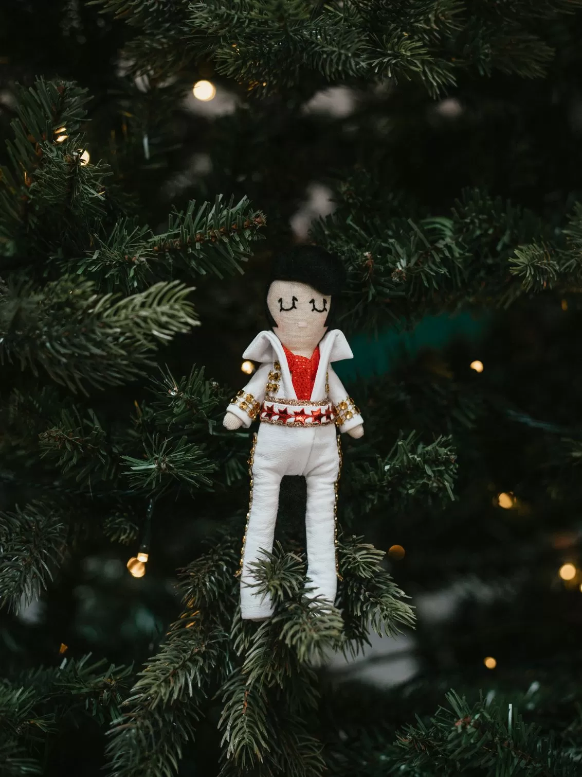 Elvis Presley seen standing in a Christmas Tree.