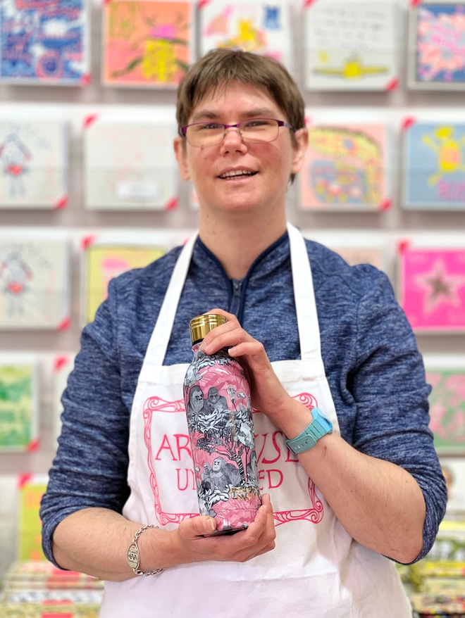 happy artist holding gorillas sustainable insulated charity water bottle in pinks & black