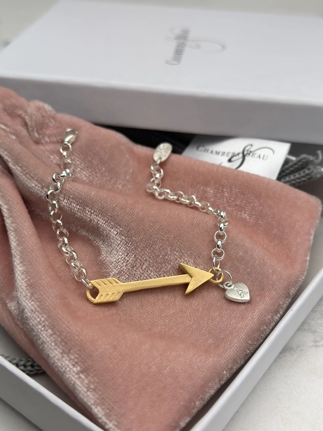 sterling silver bracelet with gold arrow charm and small personalised silver heart charm. gift box and pouch