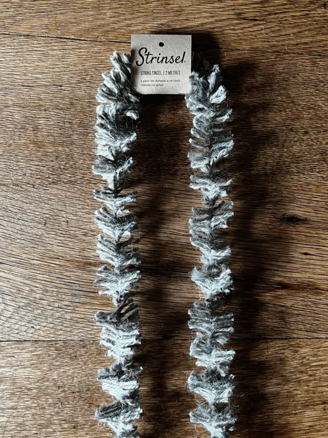 Classic Silver Strinsel AKA Jute string tinsel on an oak table