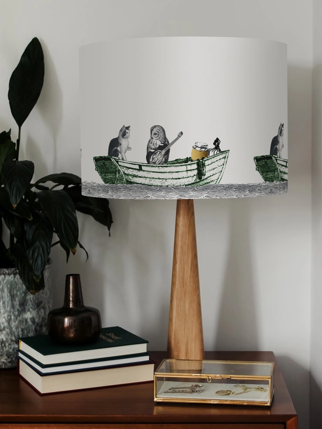 Handcrafted Owl and the Pussycat lampshade featuring a whimsical pea green boat illustration, bringing a touch of nostalgic storybook charm to the home.