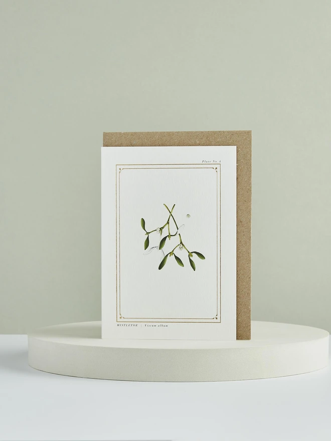 mistletoe greeting card with gold foil with a brown envelope