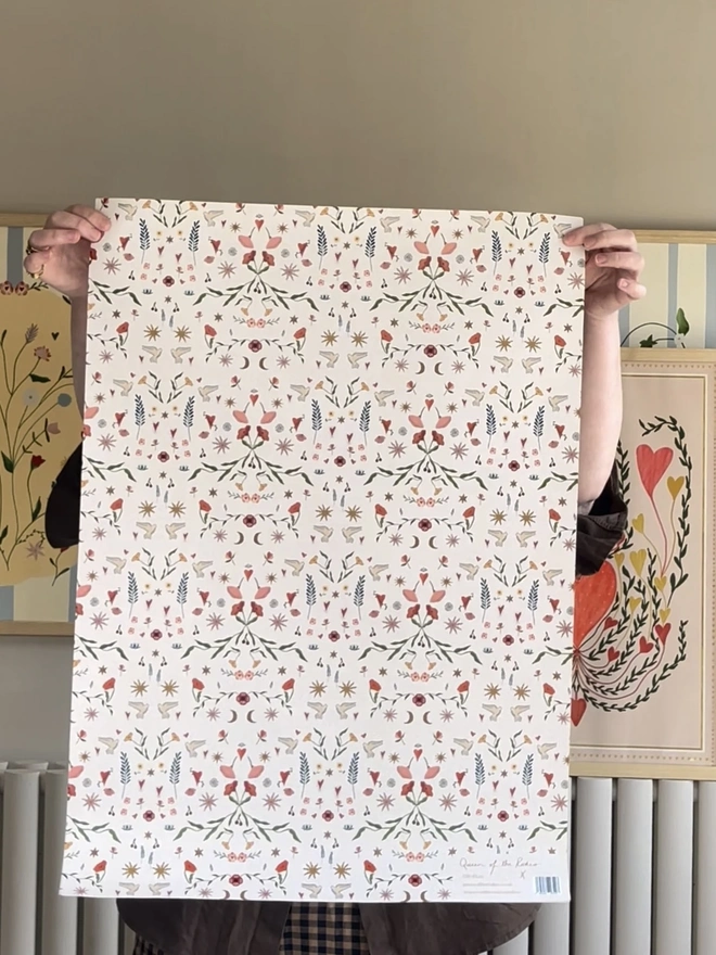 Folk Love Gift Wrap (3 Sheets), a person holding the gift wrap indoors. 