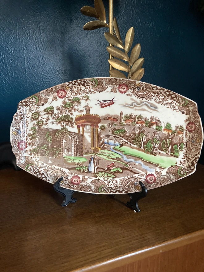Brown toned vintage plate by W.R Midwinter featuring a classic countryside scene and the addition of a Chinook helicopter in the sky