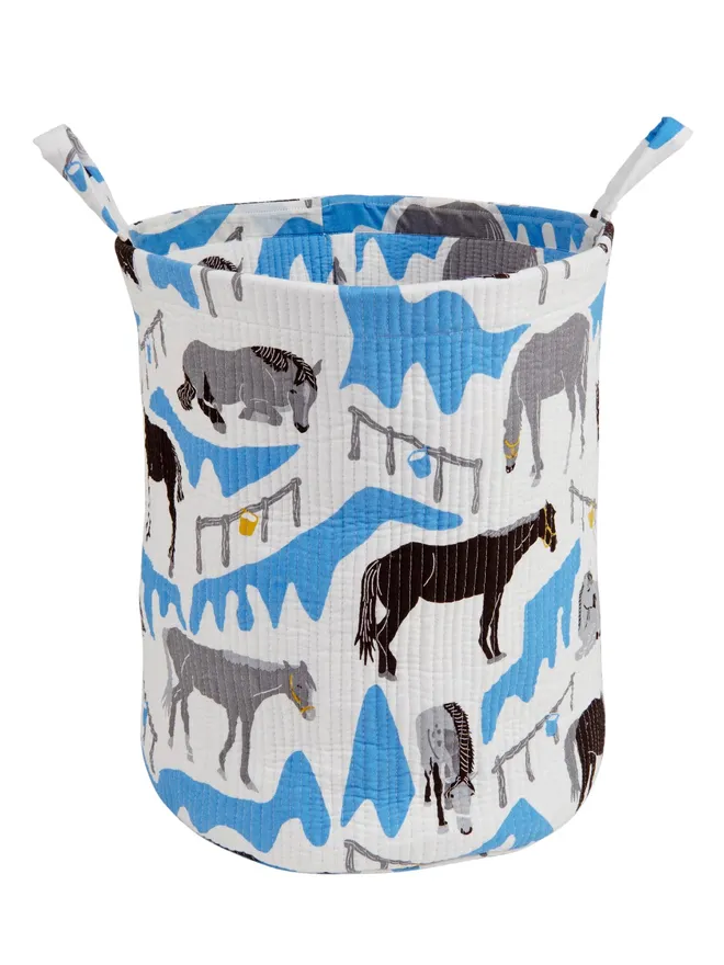 Horse Ranch Quilted Storage Basket, a blue horse pattern basket sitting against a white backdrop.