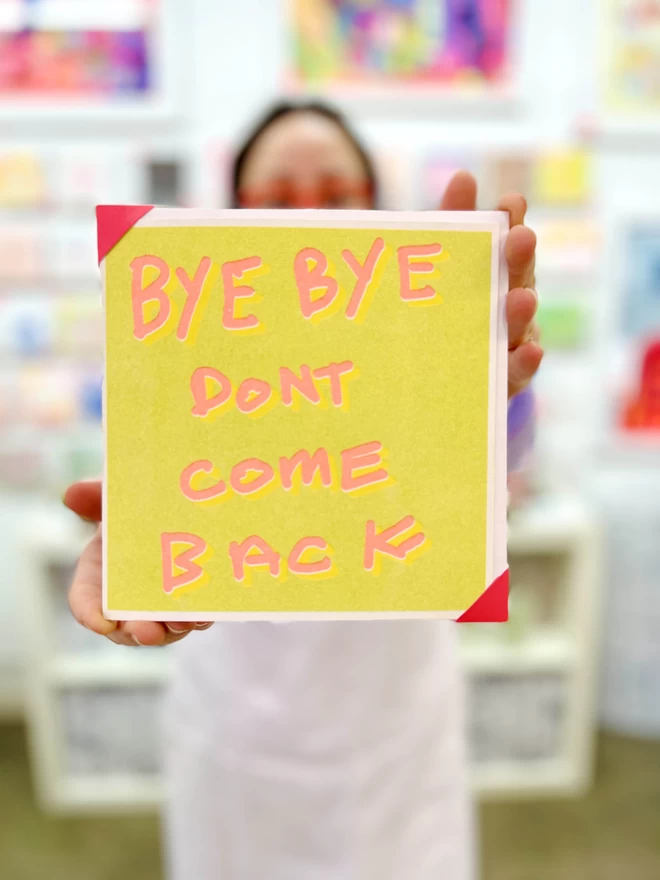 Bye Bye Don't Come Back is a good luck card with words printed in orange on bright lime green background