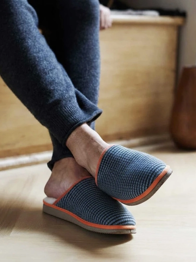 Women's Lambswool & Sheepskin Slippers, a person wearing a pair of colourful slippers indoors. 