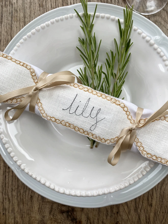 Fabric Cracker Napkin Decoration on a plate with rosemary