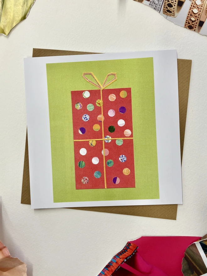 Christmas card featuring a sprinkle illustrations of a gift on a white background with collage papers