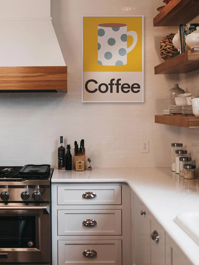 illustrated wall print featuring a mug of coffee hanging on a kitchen wall