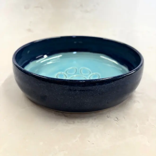 Landscape Dog Bowl, a colourful dog bowl sitting on a stone surface. 