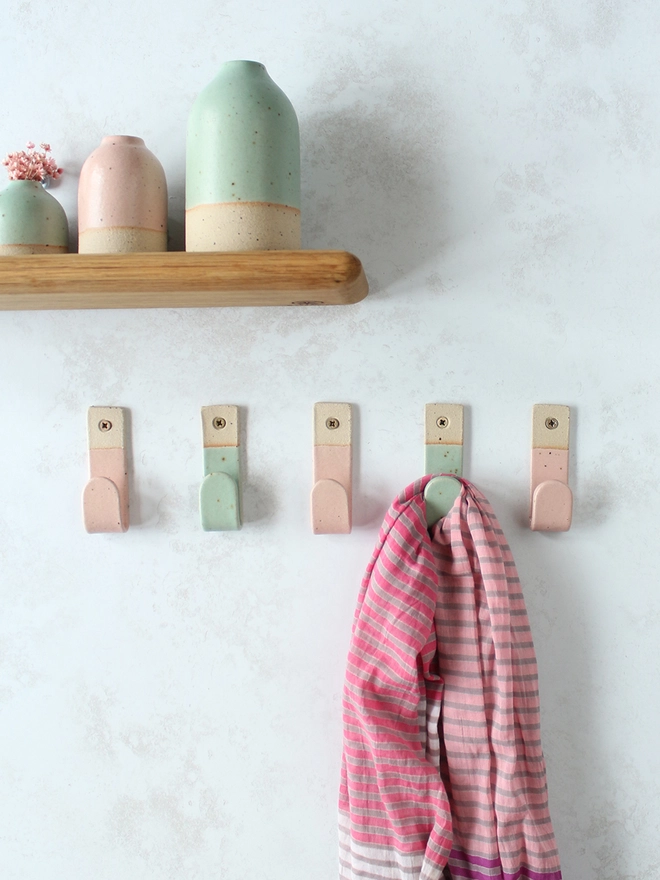 Alternating pink and mint wall hooks with matching decor
