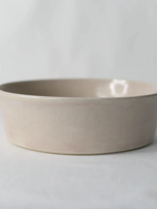 Classic Pasta Bowl, a colourful ceramic bowl sitting on a plain surface against a grey backdrop. 