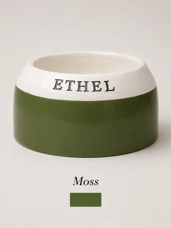 Personalised handmade cocker spaniel bowl in dark moss green with polka dots. Featuring the name Ethel on the rim