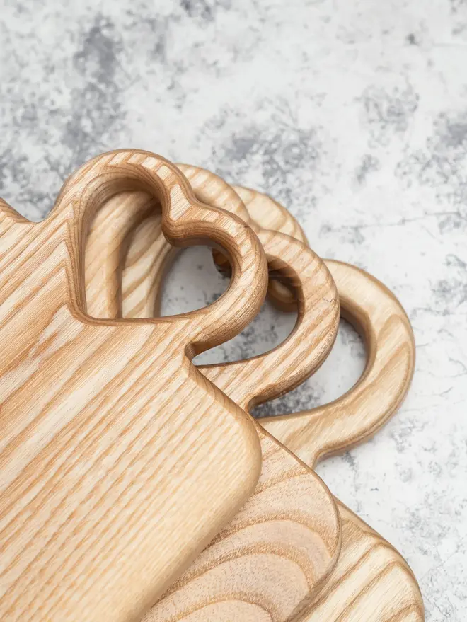 Heart Serving Boards (Set Of 3), on a marble surface. 