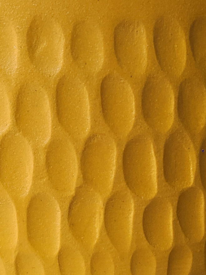 handmade textured yellow vase close up