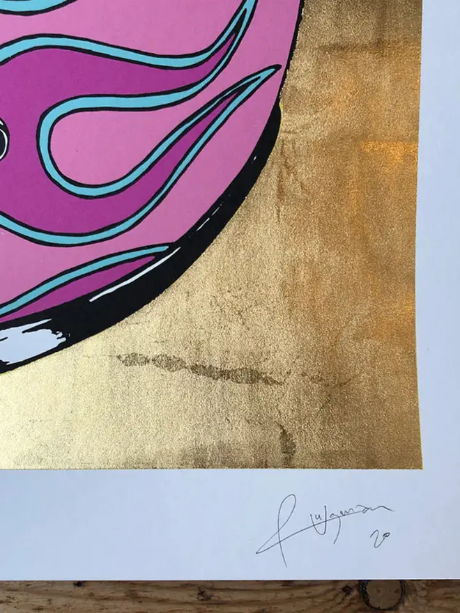 Motor cycle helmet with  a flame design on a gold  background. 