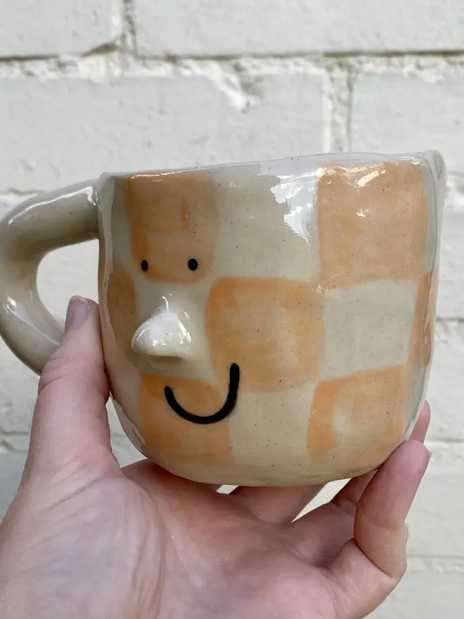 peachy checked handmade ceramic smiley face mug