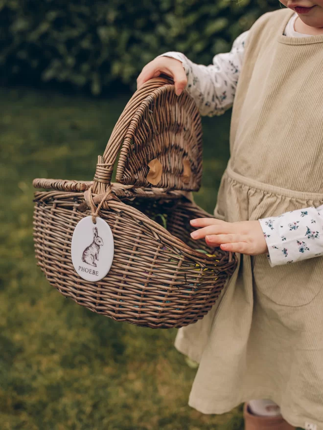 Child carrying a personalised easter bunny wicker basket