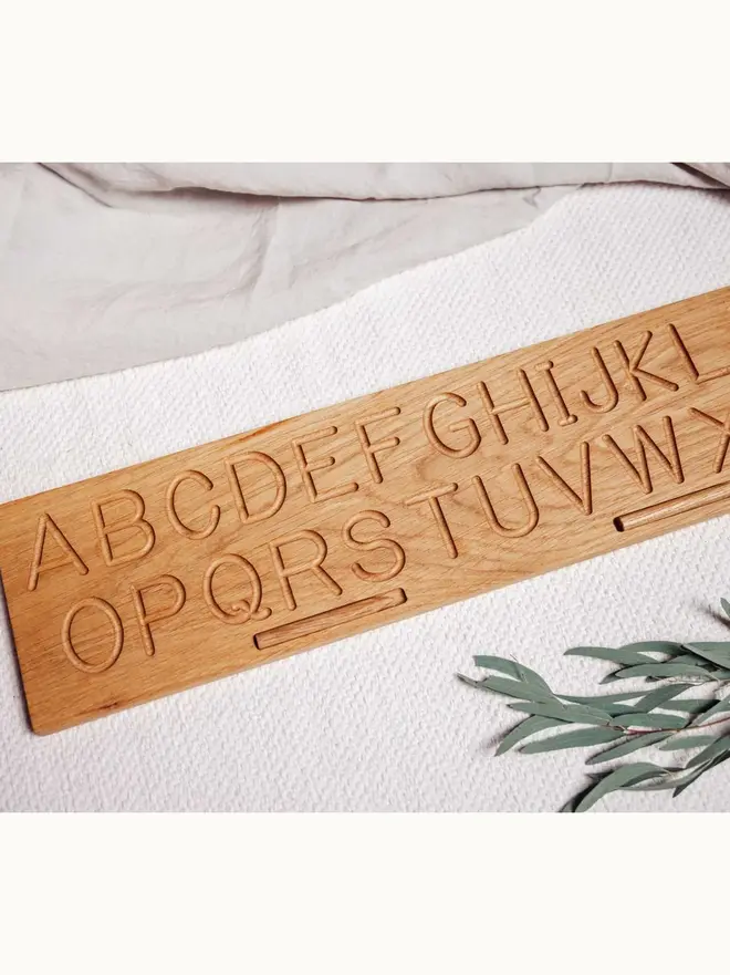 Wooden Alphabet Tracing Board Heirloom Toy, on a table. 