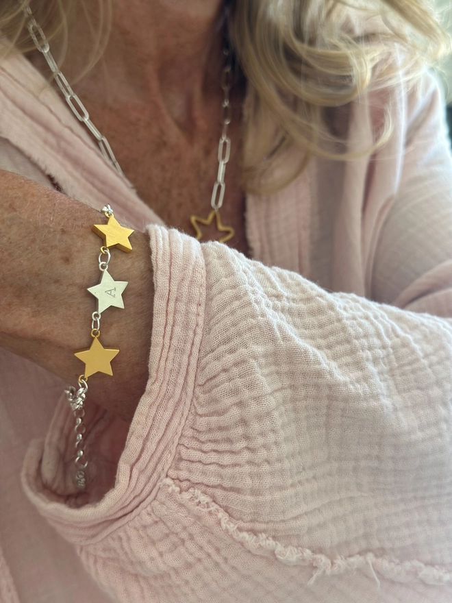Model wears a trio of stars in mixed metal on silver belcher chain bracelet