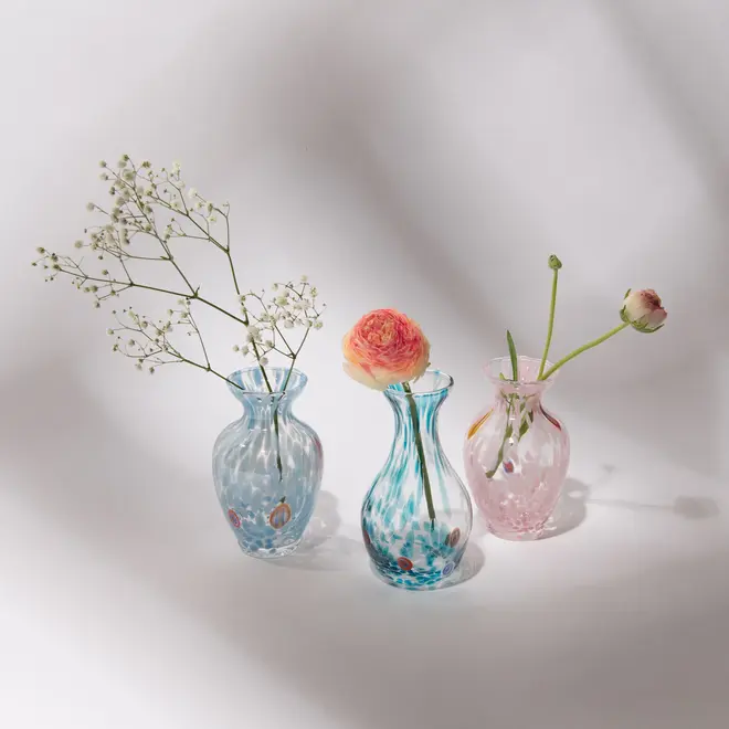 group shot of 2 blue and one pink glass vases with dried flowers