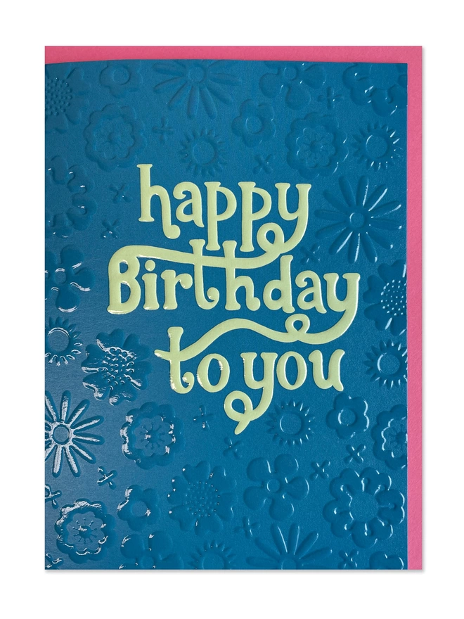 A bright blue Birthday card has a ‘Happy Birthday to you’ message in a contrasting pop of mint. The floral 70’s inspired pattern is highlighted by the spot UV and embossed finish that really makes the birthday card shine