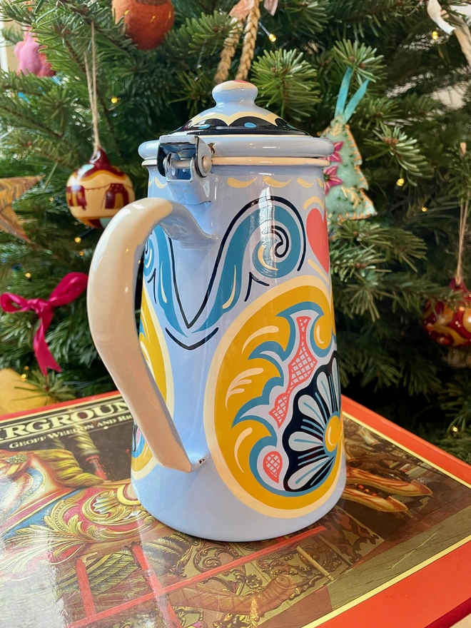 Blue enamel coffee pot hand painted with a fairground design in blue, pink and yellow
