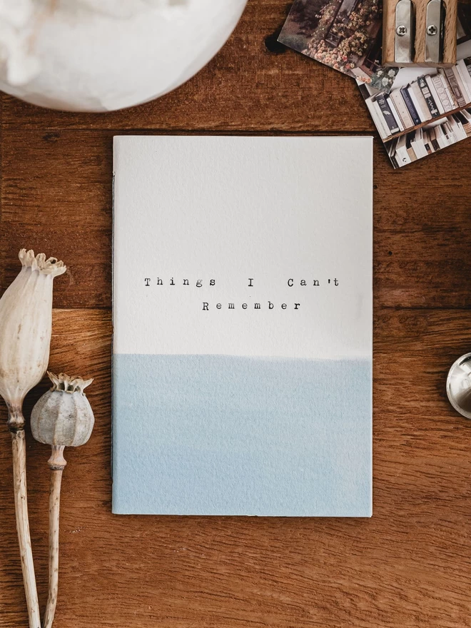 Pale blue and white personalised notebook with 'things I can't remember' typed on the cover