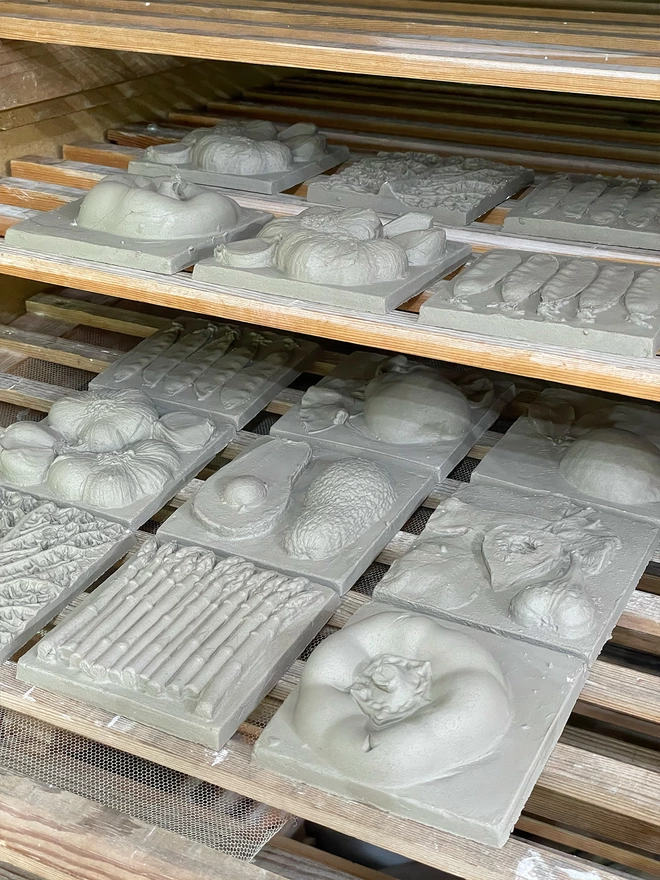 Part of the process, handmade tiles drying on special racks so they dry evenly which stops warping. .