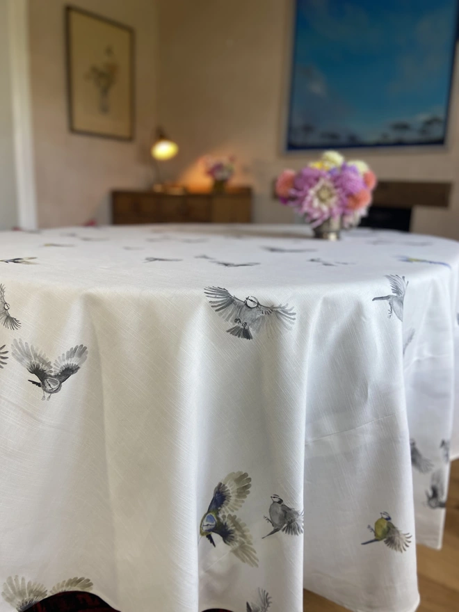 wild bird tablecloth, grey and coloured birds on a white linen