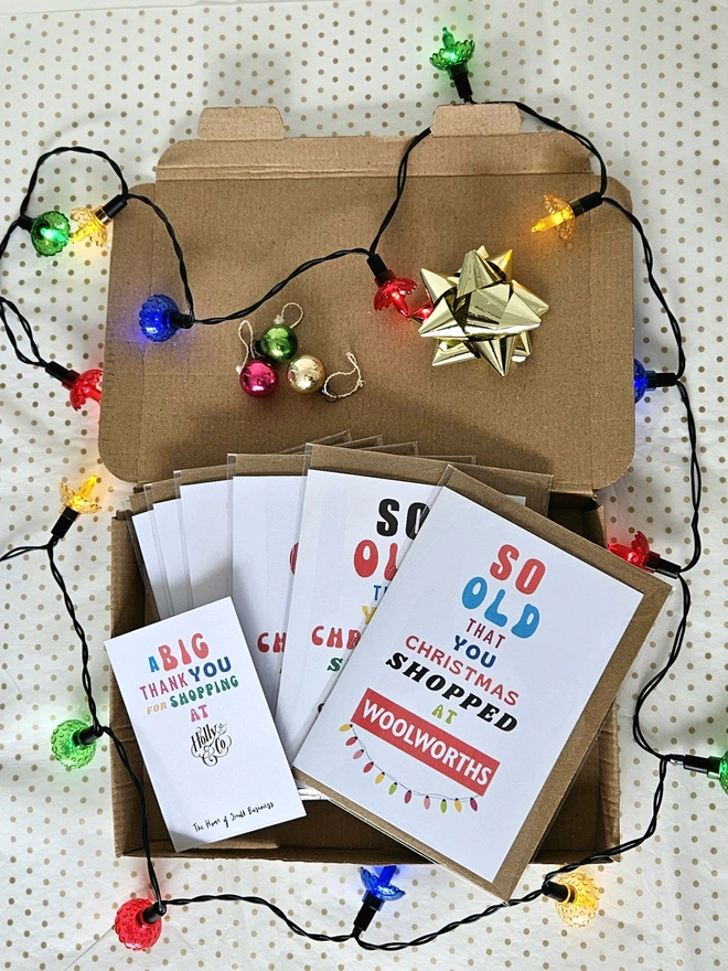 A photograph of a set of nostalgic shop cards in different designs in a box with a thank you card for shopping at Holly and Co