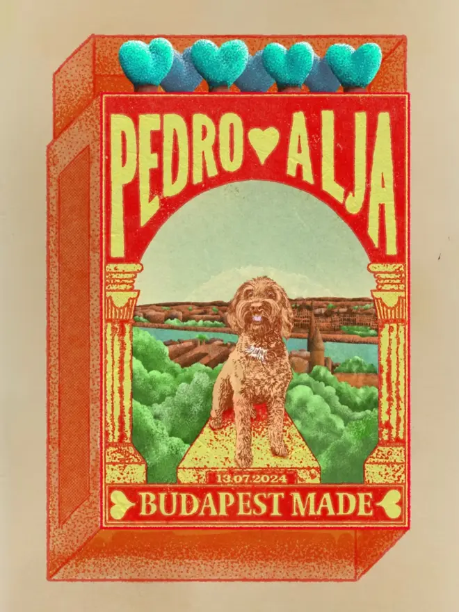
An illustrated, retro-style matchbox with a red and orange border. The main image features a light brown, fluffy dog sitting proudly on a stone pedestal. The pedestal is centered within a detailed illustration of a cityscape with a body of water, trees, and buildings. Above the dog, the names "PEDRO" and "ALJA" are written in large, yellow capital letters with a red heart between them. Below the dog, a small date, "13.07.2024," is visible. The bottom of the box has the text "BUDAPEST MADE." The match tips on the top are light blue and heart-shaped. The entire image has a grainy, vintage texture.
