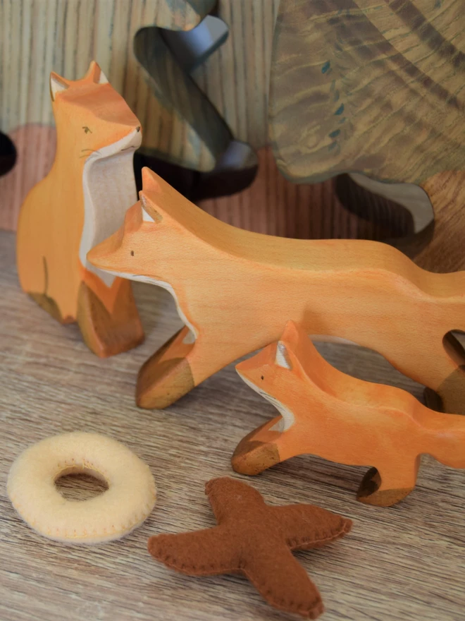 wooden fox family in play scene on shelf