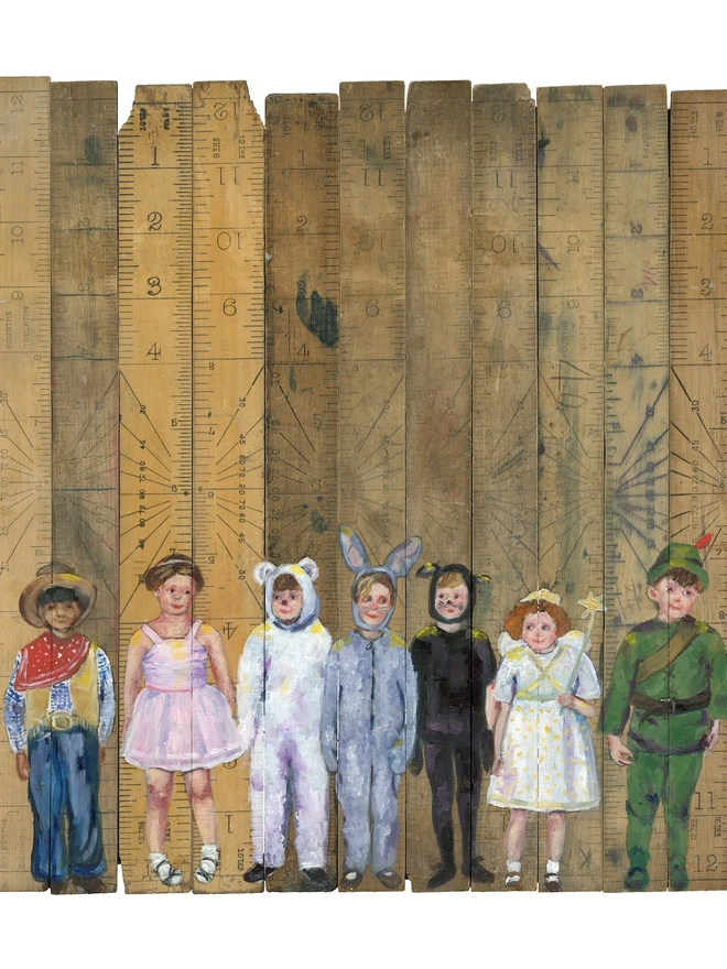 children in fancy dress painted onto vintage school rulers