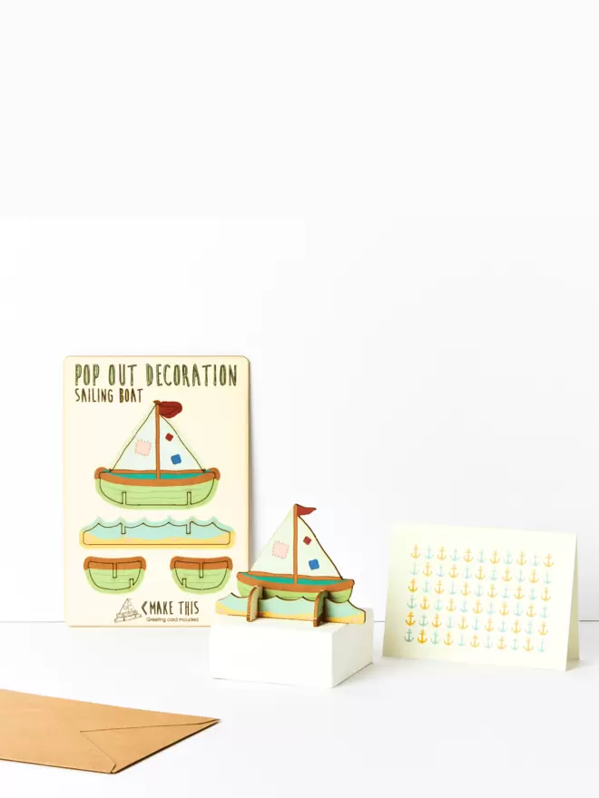 Sailing boat decoration and anchor pattern greeting card and brown kraft envelope on a white background