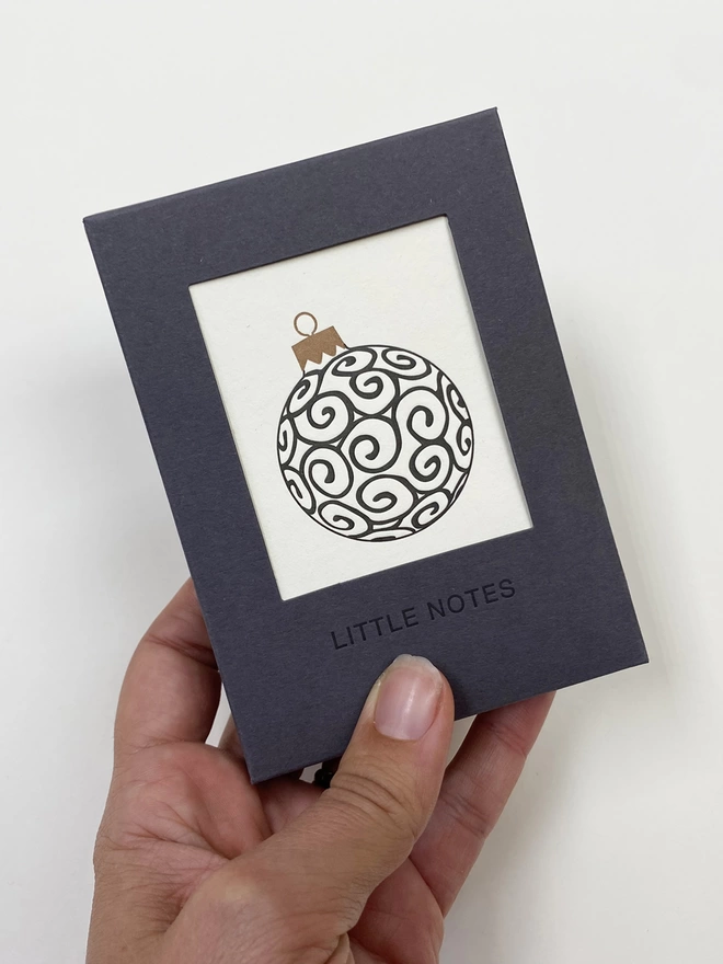 Letterpress printed gift box showing black swirl Christmas bauble all lovingly printed in the UK