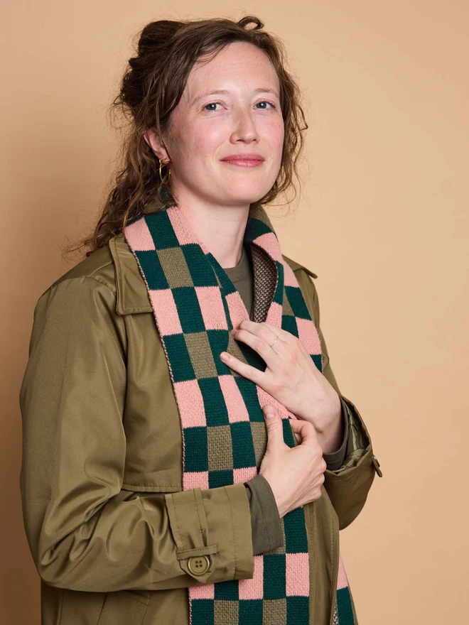 Pink And Green Patterned Wool Scarf Modelled By A Woman In A Green Coat