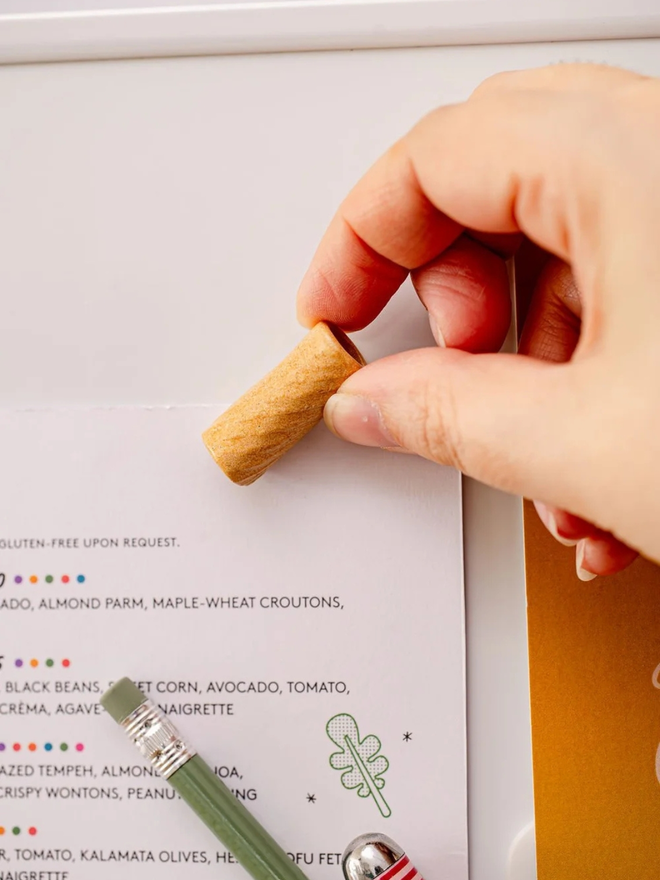 ceramic pasta magnet. a ceramic rigatoni magnet on a fridge door.