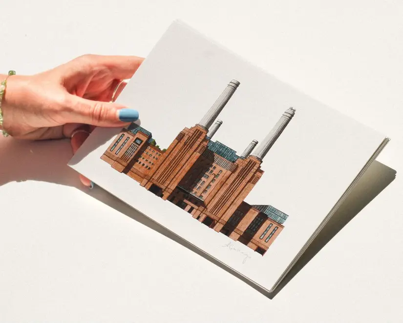Battersea Power Station Giclée Print (Unframed), a person holding a print of Battersea Power Station against a plain backdrop. 