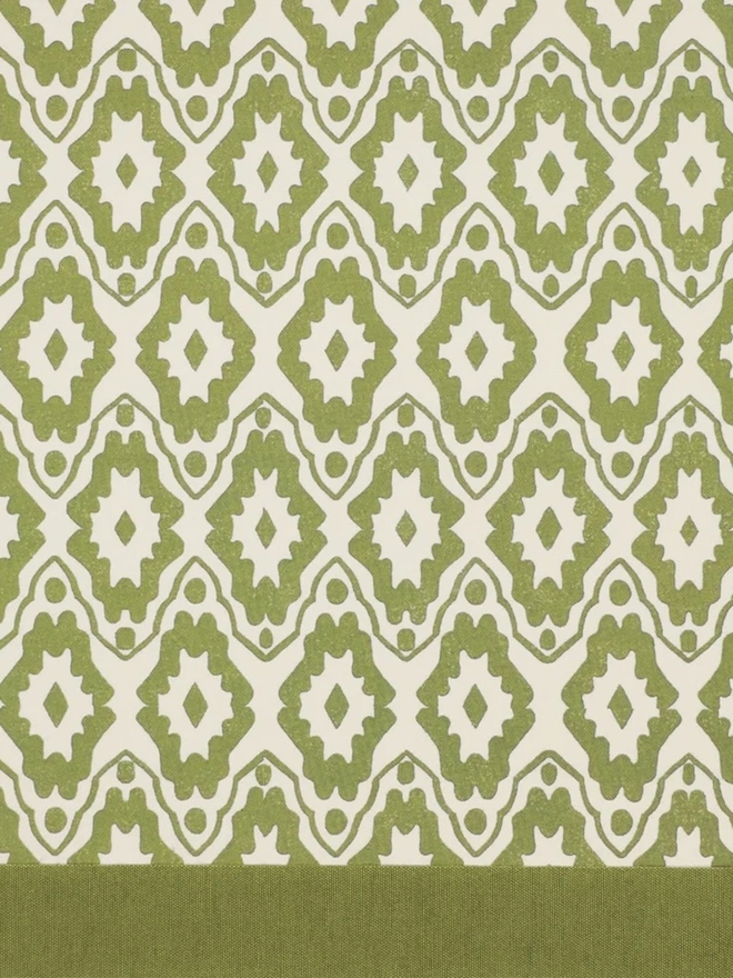 Retro Drum Lampshade. Close-up of a hand block printed lampshade showing a bold repeating geometric pattern. The colourful printed design and neat trim bring character and a handcrafted finish to any lamp.